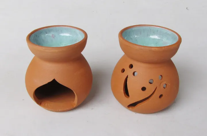Pair of small terracotta oil burners with glazed bowls